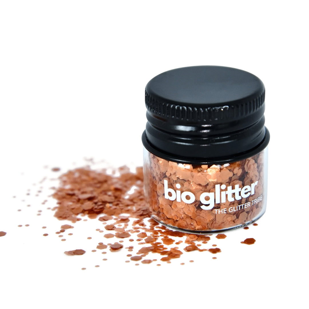 Bronze chunky biodegradable glitter in a glass jar with a black lid.