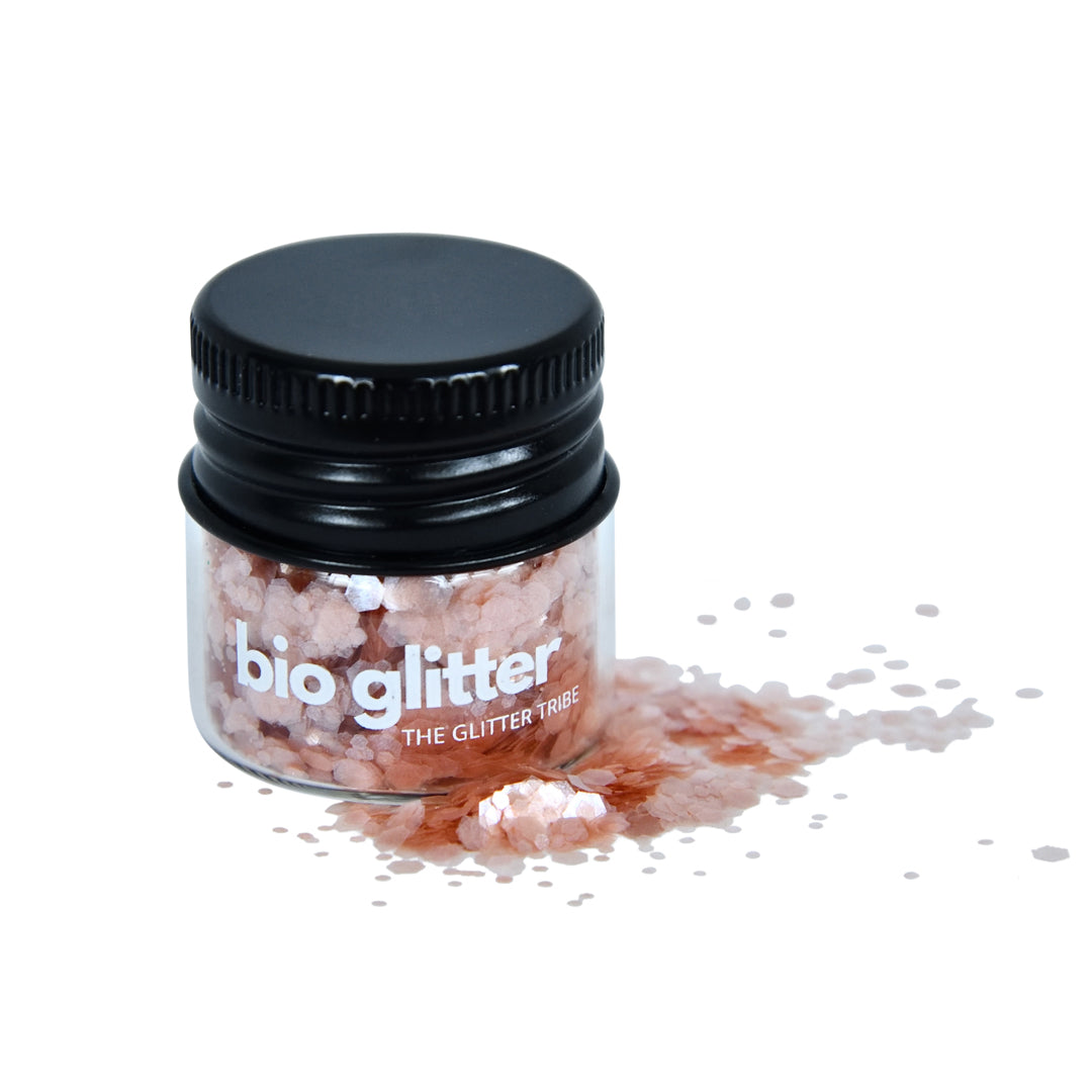 Pink bio glitter in a small jar will glitter at the side .