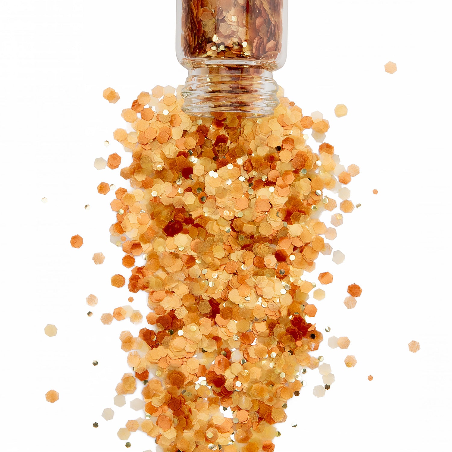 Sunset coloured sparkly bop glitter spilling out of a jar on a white background.