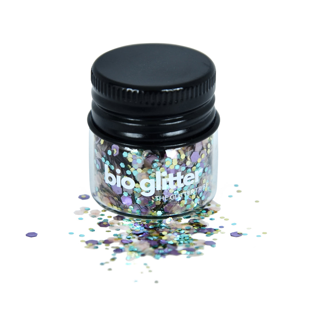 close-up of a jar filled with multicolored biodegradable glitter, with the cap on and glitter particles visible.