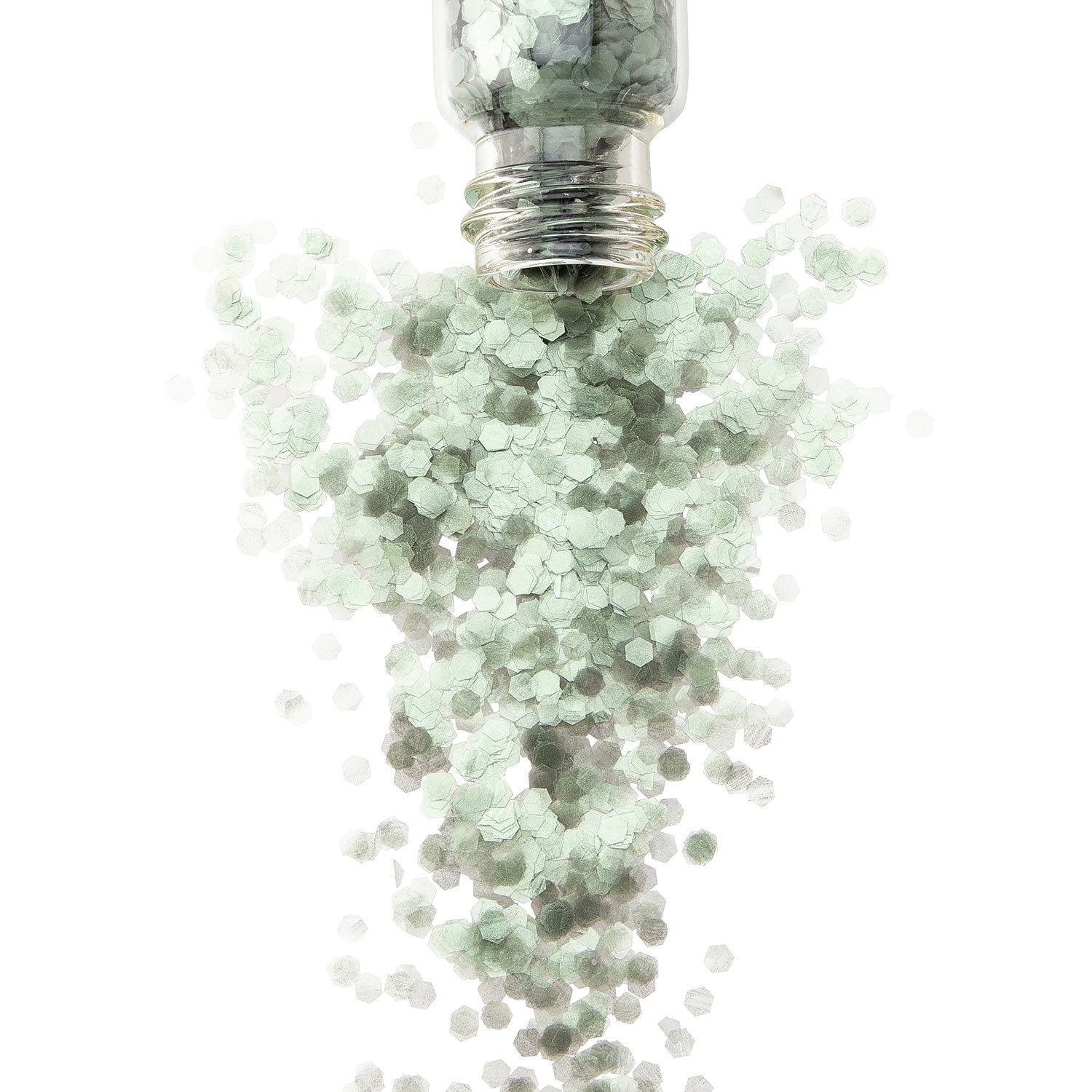 A soft green biodegradable glitter in a glass jar on a white background. Glitter is spilling out of jar.