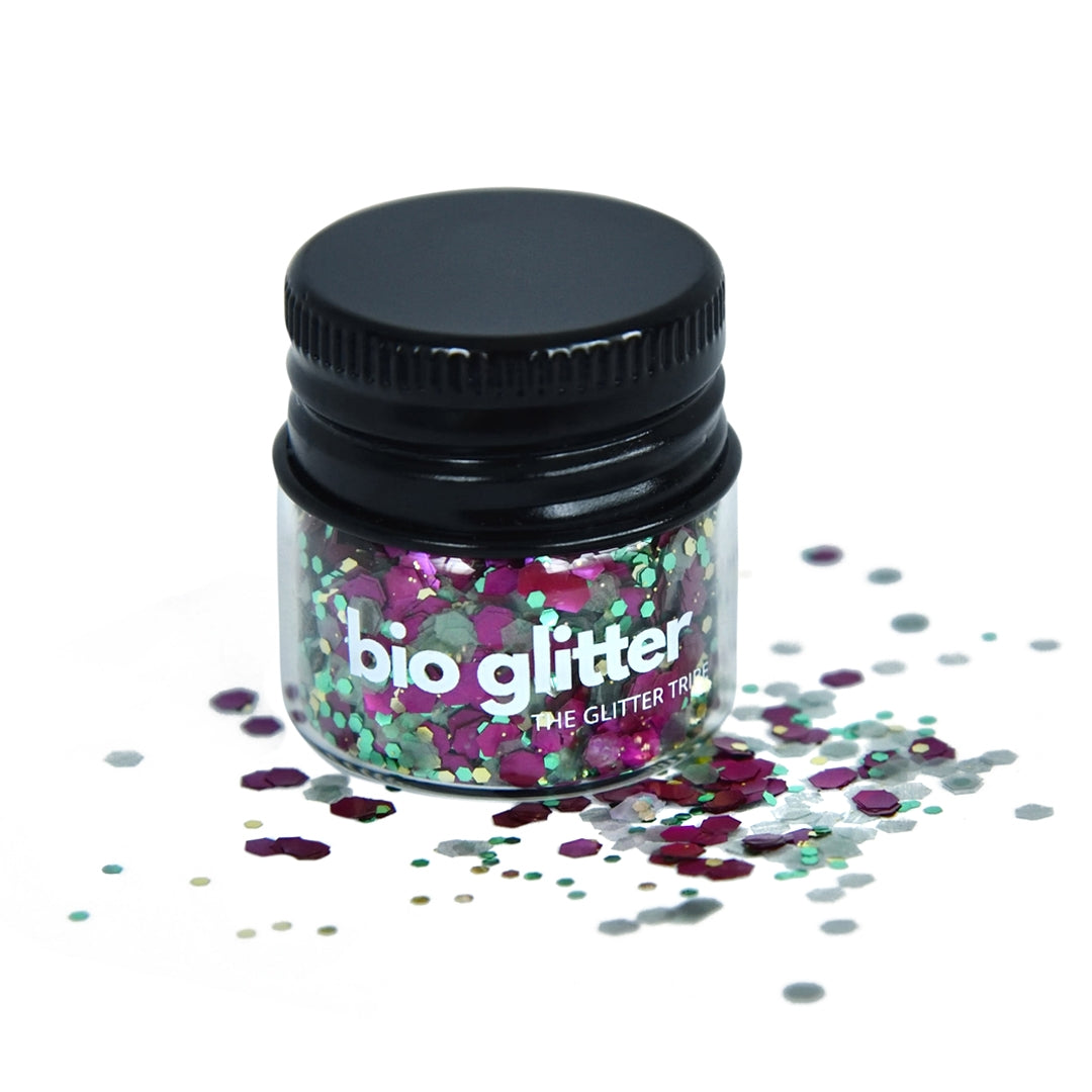 Purple and green bio glitter in a glass jar with a black lid.