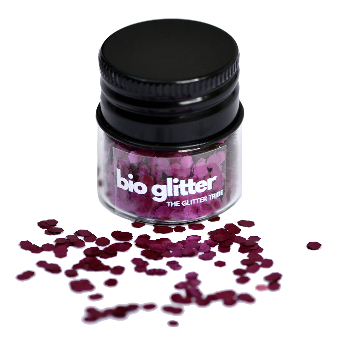 A jar with a black lid, the jar has purple glitter spilling out.