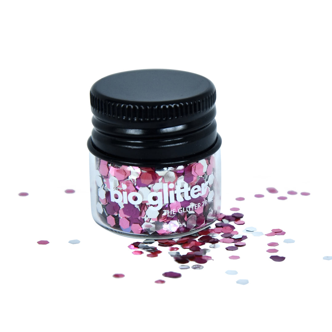 Glitter in pink and mauve tones in a glass jar.