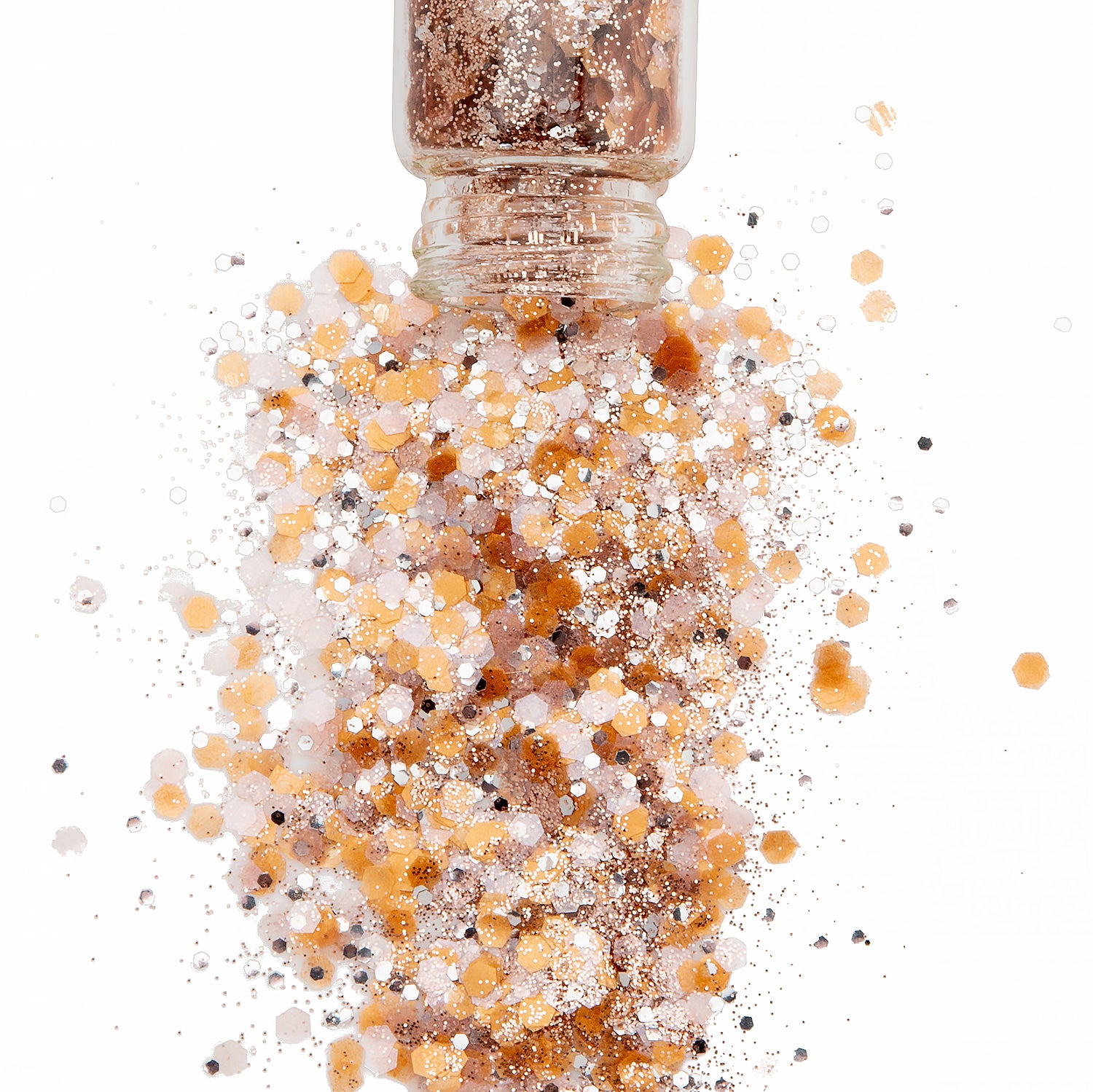 Pink Gold and silver chunky bioglitter in a glass jar with the glitter spilling on to a white background.