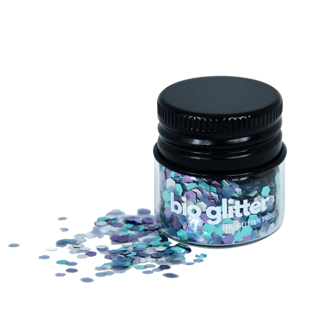 Ocean coloured bio glitter in blue and green shades in a glass jar with a black lid.