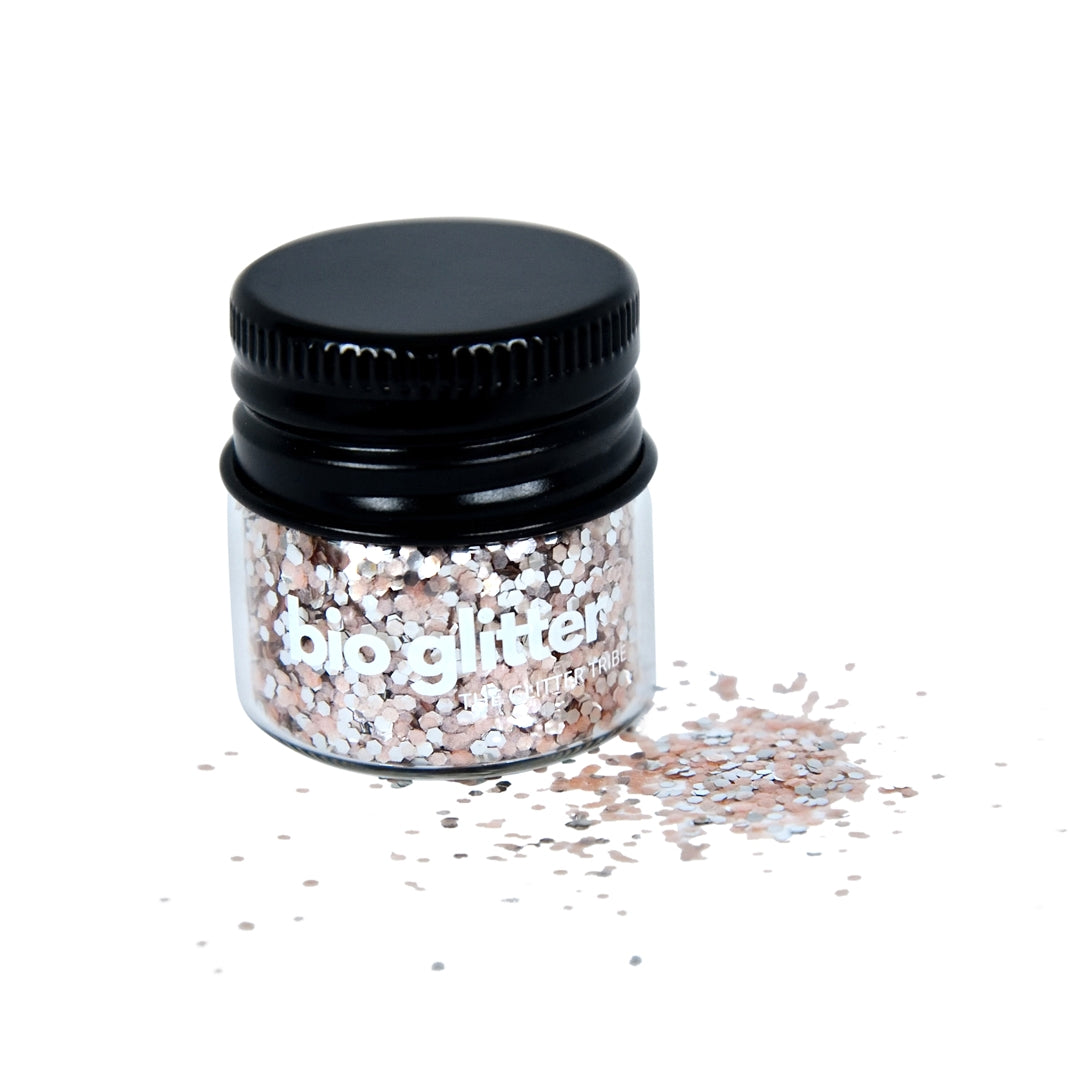 Pink and silver fine glitter sitting in a glass jar with a black lid.
