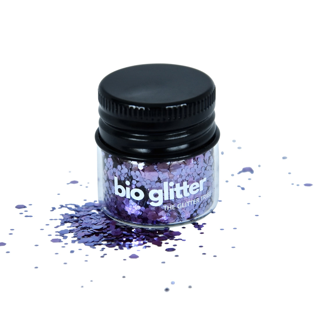 Violet glitter in a jar with a black lid on a white background,